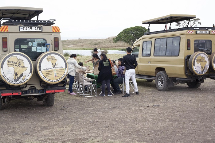Tourists at picnic lunch in Serengeti during 12 days Kilimanjaro Safari and Zanzibar Package Tourists at picnic lunch in Serengeti during 12 days Kilimanjaro Safari and Zanzibar Package